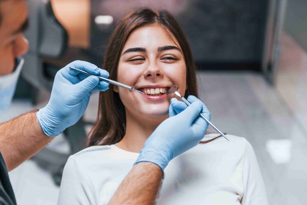 Patient smiling during a routine dental examination.