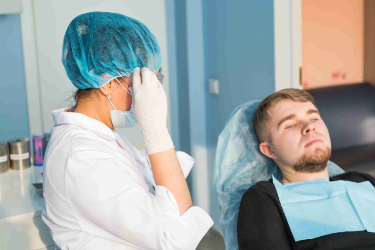Patient discussing a dental concern with a dentist during an examination.