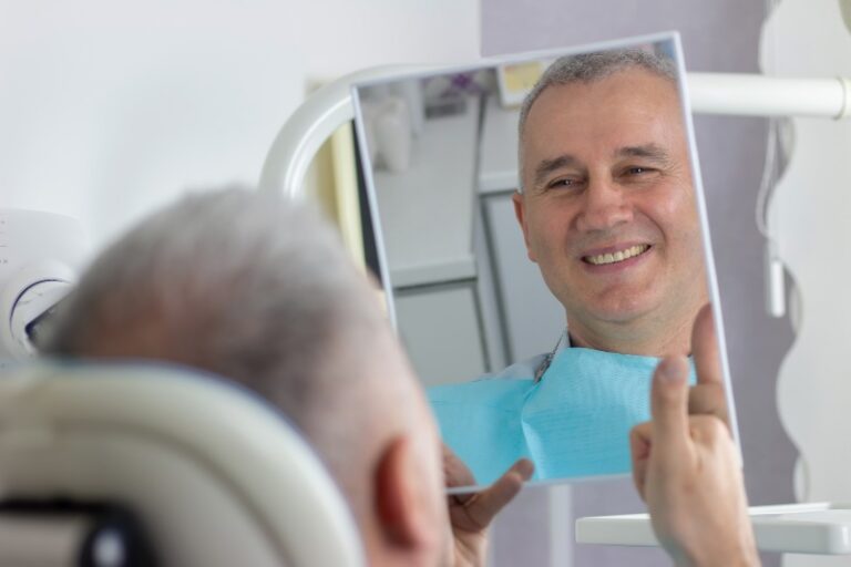 Man looking at his smile after a dental treatment